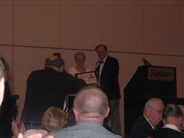 Judy with Ron's award